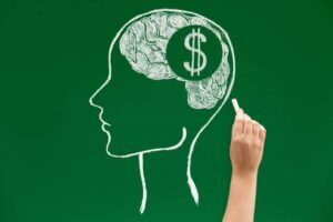 Chalk drawing of a head with a dollar symbol inside