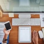 Organized office workspace with desk, laptop, and financial documents